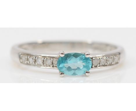 A 9ct white gold oval cut blue gemstone ring, with diamond shoulders, N, 1.6g 