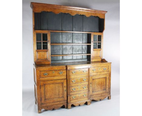 A George III oak breakfront dresser, the associated three shelf rack with two glazed doors, over three short and three dummy 