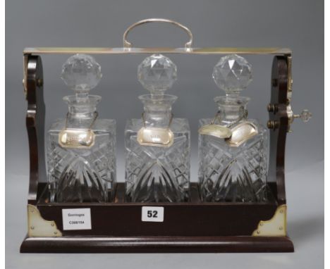 A PB &amp; S three decanter tantalus with five silver labels - Vodka, Gin, Scotch, Whiskey