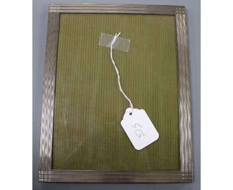 A Tiffany &amp; Co engine turned silver photograph frame, 25.4cm.