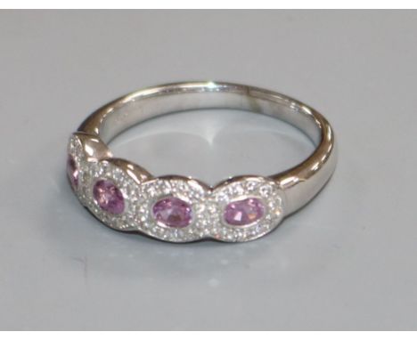 An 18ct white gold, pink sapphire and diamond quadruple cluster ring, size R.