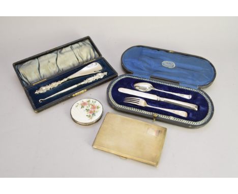 A silver and enamel compact, Henry Clifford Davis, Birmingham 1936, of circular form, the cover with white enamel ground with