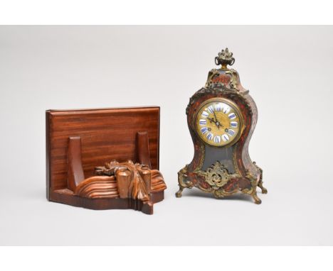 A French Boulle style cut brass and red tortoiseshell mantel clock, the rococo style case with flower urn finial, ormolu moun