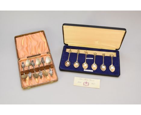 A cased set of six Silver Jubilee souvenir spoons, hallmarked London 1976, each with cast finial, together with a cased set o