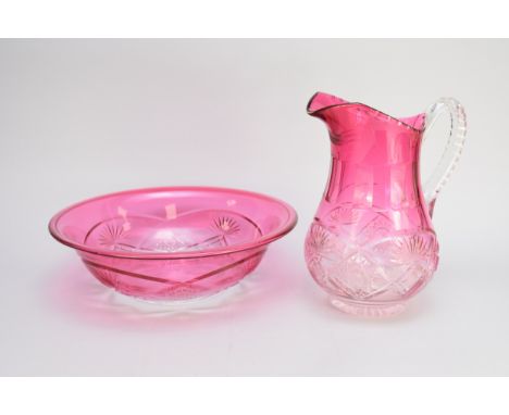 A large and unusual Edwardian cut glass cranberry wash jug and basin, jug 27cm high and bowl 40cm diameter (2)