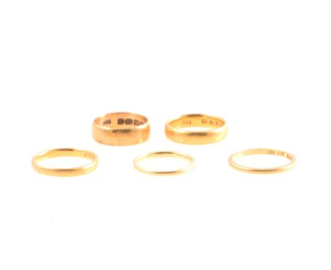 Five gold wedding bands. All with a plain polished finish. 18 carat yellow gold 5.7mm wide, size L, 4.7gm. 18 carat yellow go