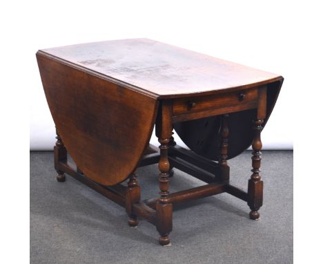 Titchmarsh &amp; Goodwin oak gateleg dining table, oval top with two drop leaves, two frieze drawers, baluster gate legs, the