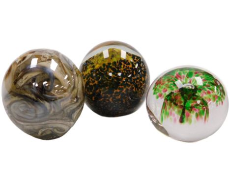 A Mdina glass paperweight, Wedgwood paperweight, and a further weight decorated with brown swirls, indistinctly signed.  (3)