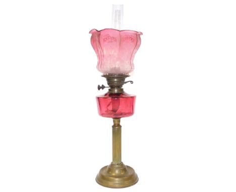 A late 19thC Duplex brass oil lamp, with fluted column, ruby glass reservoir, with chimney, floral etched clear to cranberry 