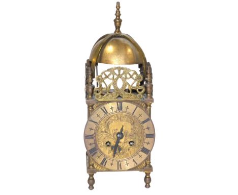 An early 20thC French brass cased lantern clock, the rectangular dial with foliate and floral engraving, chapter ring bearing