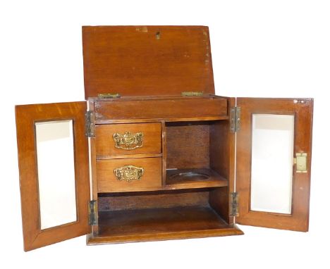 A Victorian mahogany smoker's cabinet, with two glazed doors, enclosing two drawers, recess for mixing bowl and shelf under, 
