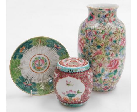 A 20thC Chinese porcelain famille rose vase, of ovoid form, decorated in an all over pattern of flowers on a gilt ground, red