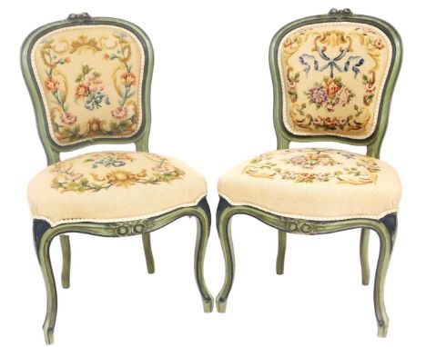 A pair of Victorian green painted spoon back chairs, with overstuffed floral tapestry seat and back, raised on cabriole legs,