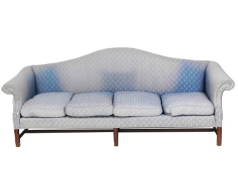 A George III mahogany four seater hump back sofa, upholstered in turquoise foliate fabric, with loose cushion seats, raised o