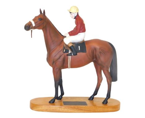 A Beswick matt figure of Red Rum, Brian Fletcher Up, Winner of The Aintree Grand National 1973 &amp; 1974, on an oval wooden 