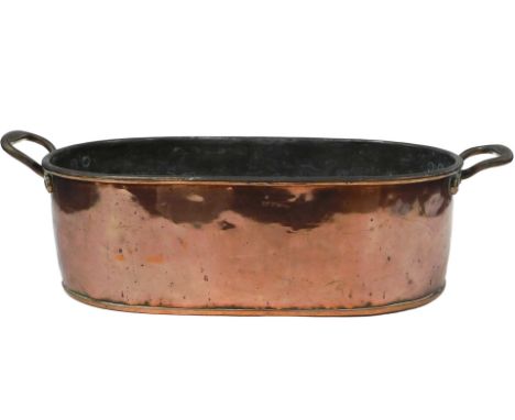 A Victorian copper twin handled oval fish kettle, numbered 21, 68cm wide.
