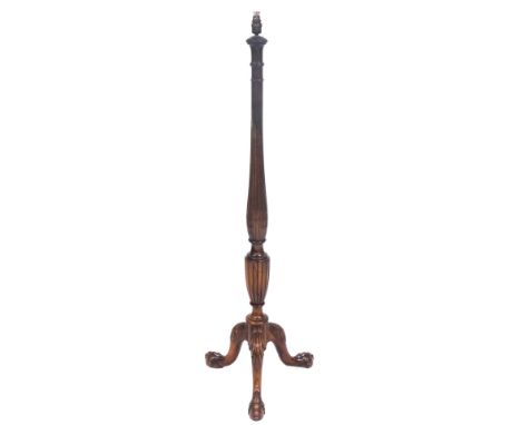 An early 20thC mahogany standard lamp, with a fluted and leaf carved column, above three leaf capped cabriole legs, on claw f