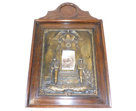 A World War I oak and gilt plaster memorial frame, the pediment with a circular recess to hold a widow's penny, above a recta