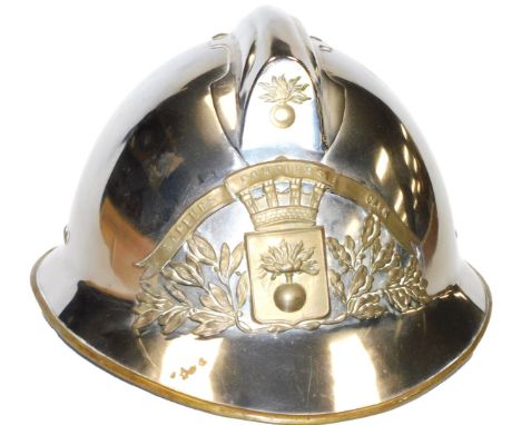 A late 20thC French white metal fireman's helmet, with a plaque bearing a coat of arms, beneath a banner "Sapeurs, Pompiers, 