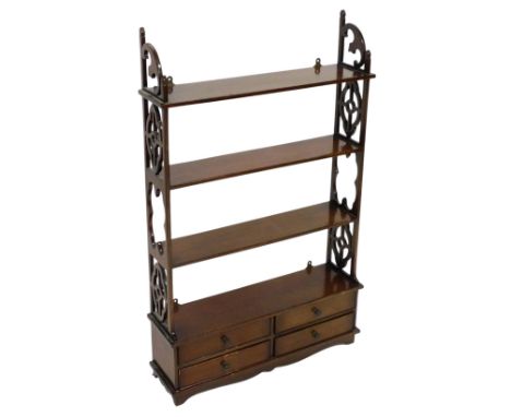 An late 20thC mahogany wall mounted bookcase, of three shelves, with carved and fretwork sides, over four frieze drawers, rai