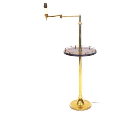 An early 20thC brass and mahogany library standard lamp, with an angular arm, above a cylindrical column, with a circular gal