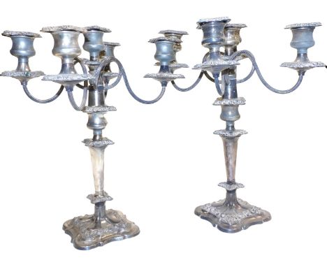 A pair of silver plated four branch candelabra, embossed with flowers and foliate scrolls, 41cm high.