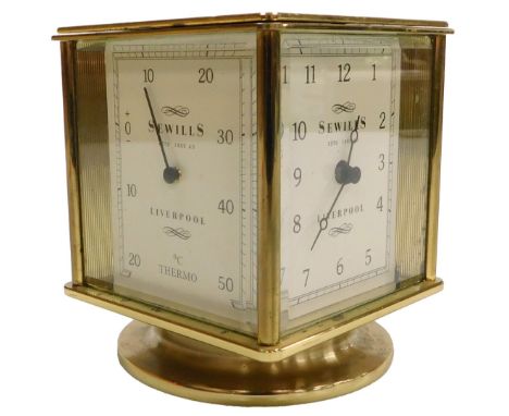 A Sewills of Liverpool brass revolving desk clock, with a clock dial bearing Arabic numerals, and dials for hygrometer, barom