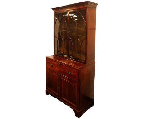A George III mahogany secretaire bookcase, with satin wood and ebony cross banding, with an outswept pediment over a pair of 