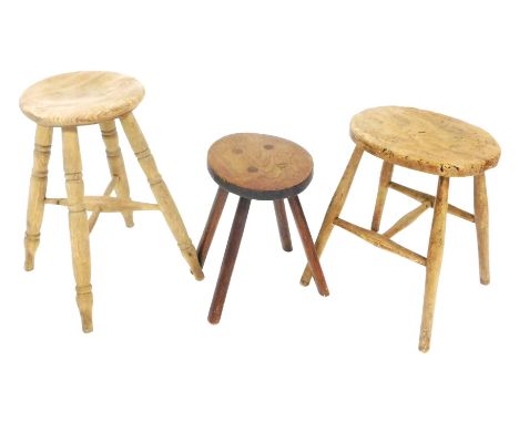 A late 19thC elm milking stool, raised on turned legs, united by a h-frame stretcher, 44cm high, further stool, 52.5cm high, 