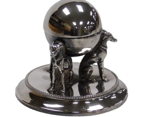 A Victorian silver plated inkwell, of spherical form, raised on three seated greyhound supports, above a circular base, 12cm 