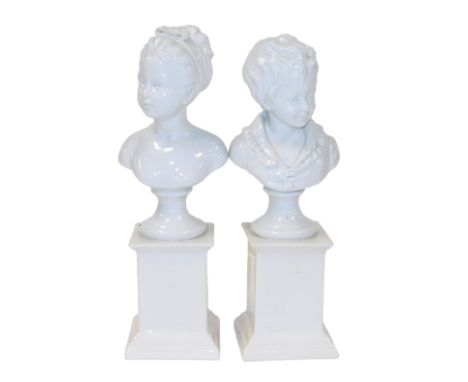 A pair of Porcelan au de Paris white glazed porcelain busts on pedestals, of a boy and girl, after F Kessler, inscribed D'apr