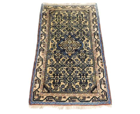 An Iranian cream ground rug, with a central floral medallion and floral field, within repeating floral borders, 126cm x 72cm.