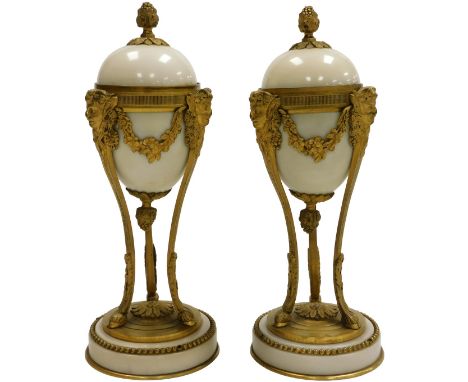 A pair of late 19thC Louis XVI marble and ormolu cassolettes, the lid with a grape finial, inverting to a candle holder, the 