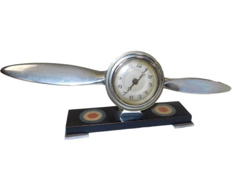 An early 20thC RAF clock, circular silvered dial bearing Arabic numerals, clockwork movement, the case of propeller form, rai