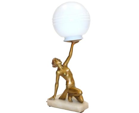 An Art Deco gilt figural desk lamp, modelled as a semi-clad kneeling lady, raising her left arm holding the fitting, with a w