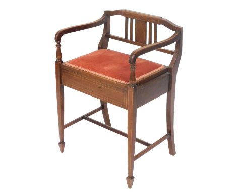 An Edwardian mahogany and boxwood line inlaid piano chair, with an upholstered hinged seat, opening to reveal a recess, raise