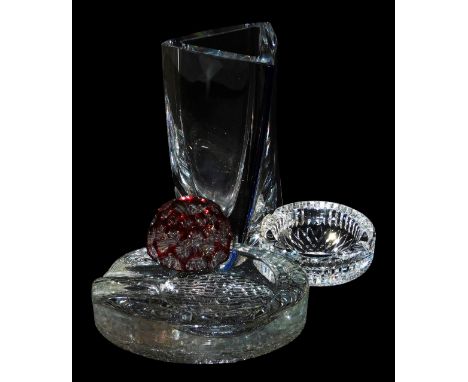 A Waterford crystal ashtray, ruby faceted glass paperweight, oval textured glass ashtray and a Kosta Boda Sails vase, designe