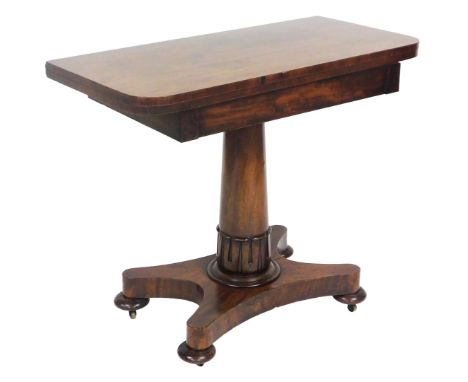 A Regency mahogany demi lune fold over card table, with a green baize interior, raised on a lappet carved and cylindrical col