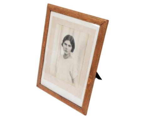 A gilt tooled calf leather strut photograph frame, containing a photographic portrait of a lady, signed by the photographer, 