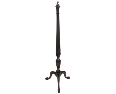 An early 20thC mahogany standard lamp, of baluster form, with fluting and foliate and corn carving, raised on three cabriole 
