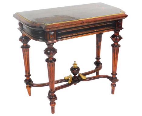 A Victorian oak fold over card table, stained and gilt painted, the fold over top with green baize interior, raised on fluted