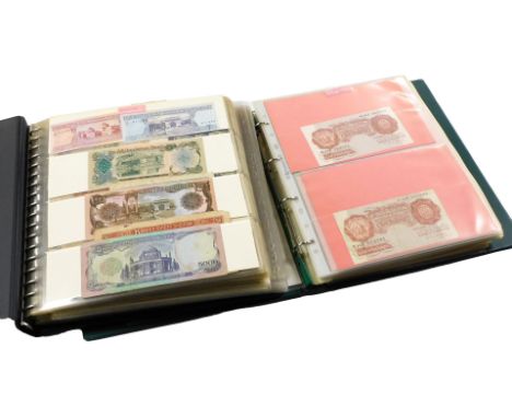 Two albums of English and world banknotes, including three blue one pound notes, Chief Cashiers K O Peppiatt and two five pou