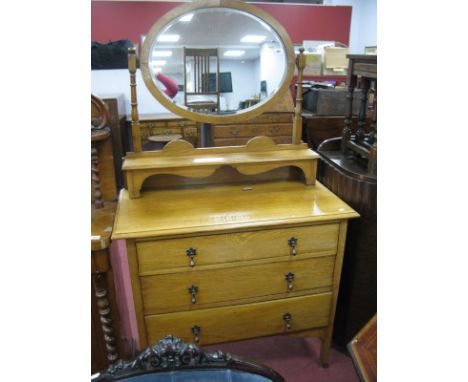 Early XX Century Light Oak Dressing Table, having oval mirror and three graduated drawers, 91cm wide.