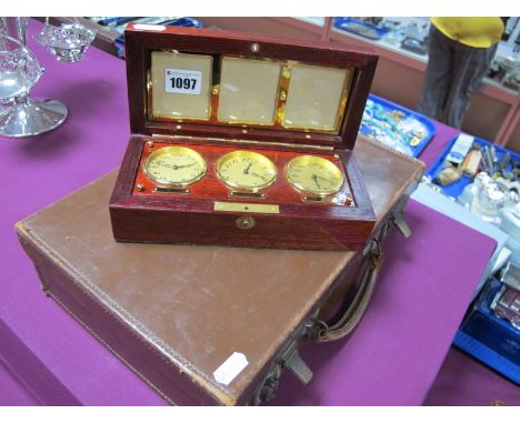 Asprey; A Modern Wooden Case, the fitted interior with central clock; a vintage brown brief/travelling case. (2)