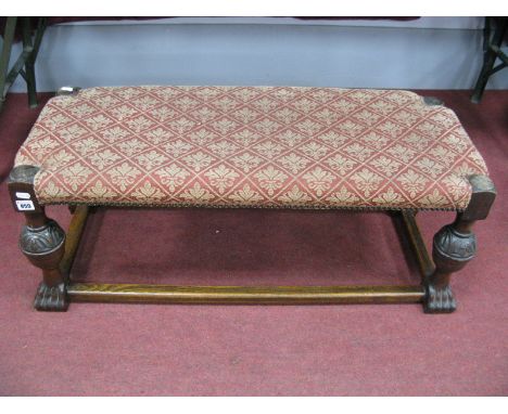 An Early XX Century Oak Rectangular Shaped Stool, with upholstered top, on cup cover supports, paw feet 92cms x 36cms