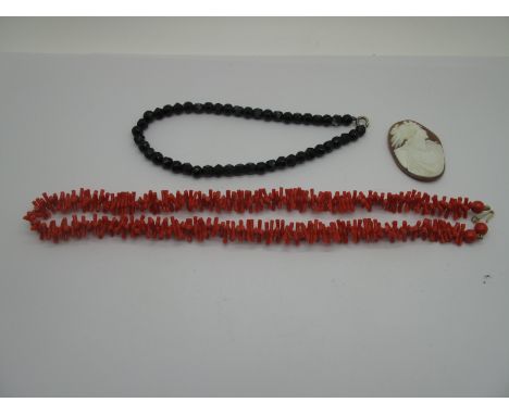 A Coral Coloured Twig Style Necklace, a jet coloured faceted bead necklace and an oval shell carved cameo style panel only, d