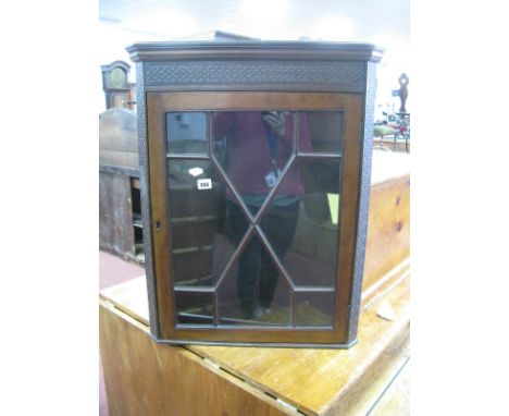 Early XX Century Mahogany Glazed Corner Cupboard, with blind fret decoration, glazed astragal door, one internal shelf.