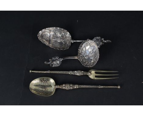 A silver gilt anointing spoon and fork together with two continental silver spoons with embossed decoration to bowls