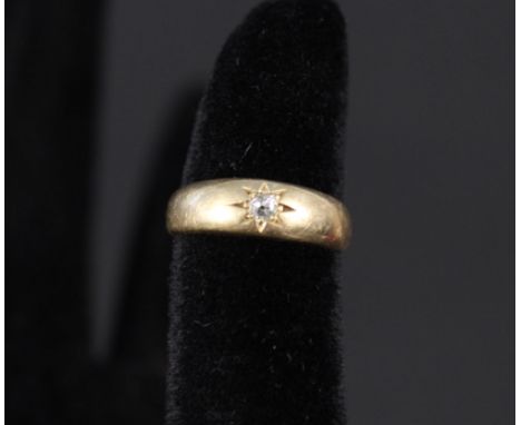 An 18ct gold diamond set band ring, size K