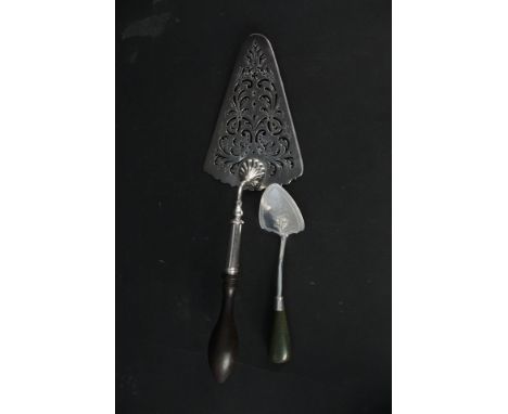 A large Georgian silver trowel shaped server with pierced design and wood handle, London 1758, together with a smaller simila